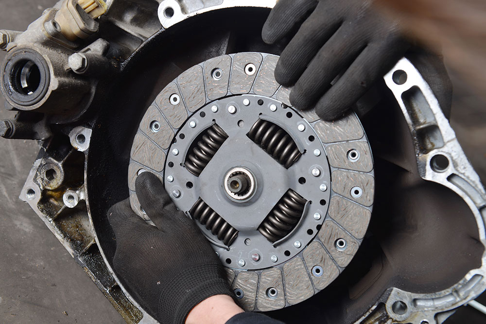 Two hands on a car's clutch judder
