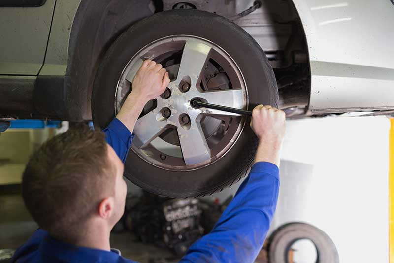car mechanic changing tyre
