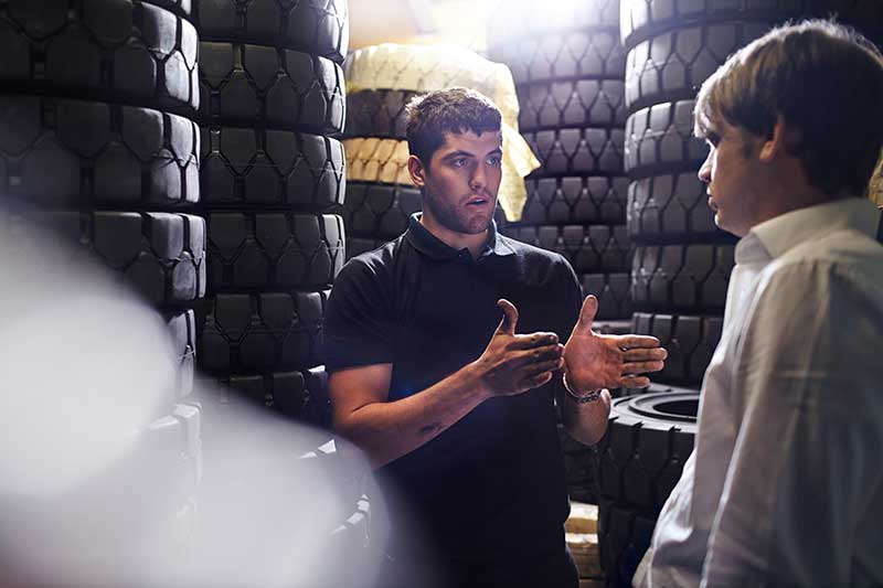 customer choosing new tyres in car shop